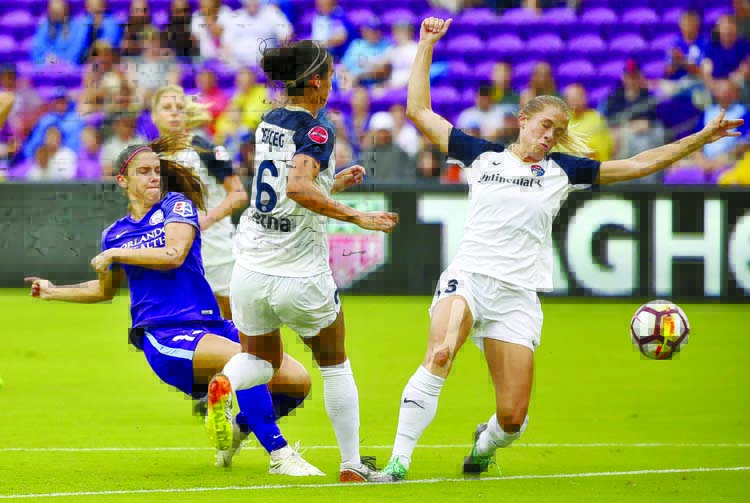 Orlando Pride's Alex Morgan (left) takes a shot past North Carolina Courage players Abby Erceg (6) and Abby Dahlkemper (right) during an NWSL soccer game at Orlando City Stadium on Saturday.