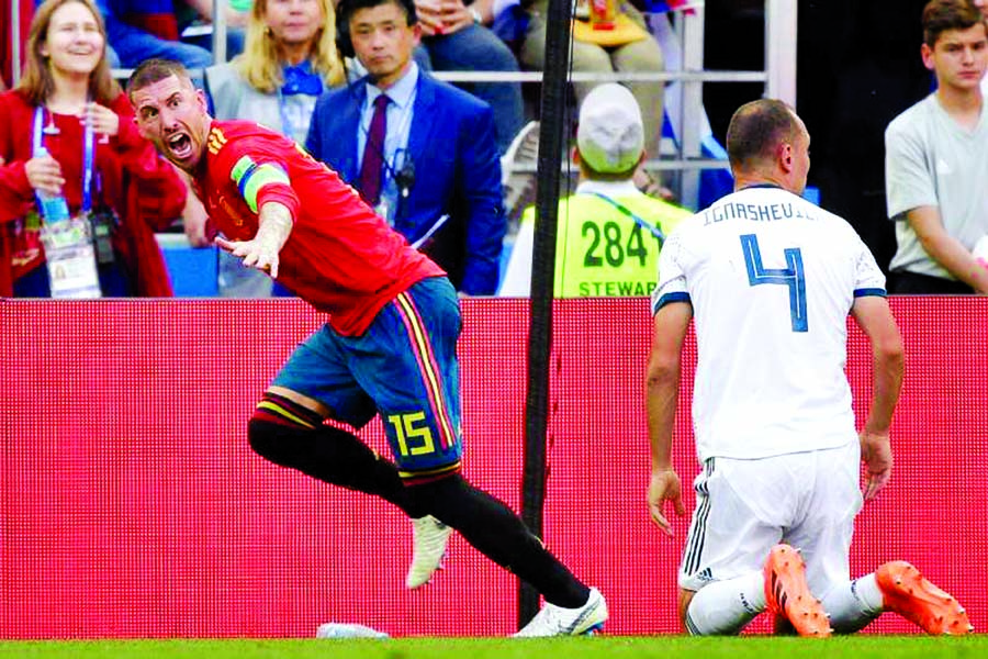 Sergio Ramos of Spain celebrates after Sergey Ignashevich of Russia scores an own goal in the first half at the Luzhniki Stadium in Moscow on Sunday. (Result 1-1 at half-time.) Internet photo