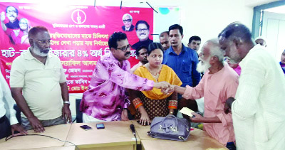 RANINAGAR (Naogaon): Israfil Alam MP giving financial aid among the poor Freedom Fighters in Raninagra Upazila on Monday.