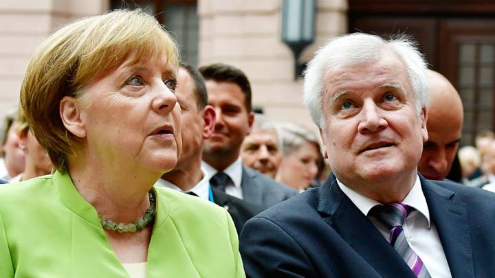 German Chancellor Angela Merkel and Interior Minister Horst Seehofer attend an event to mark World Refugee Day at the German Historical Museum in Berlin.