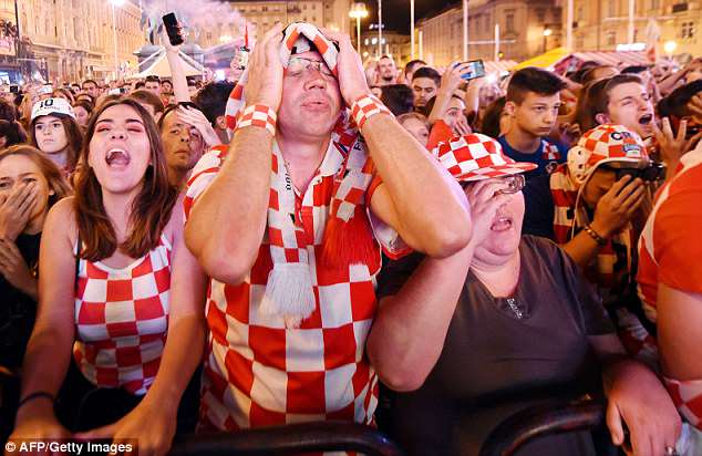 Croatia narrowly beat Denmark 3-2 on penalties - which explains the tense expression on fans' faces in this photo.