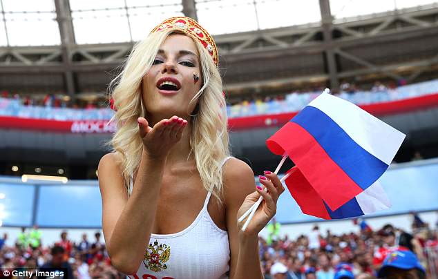 A delighted Russian fan blows a kiss after watching her team win