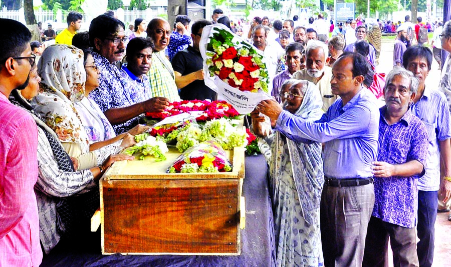 People from all walks of life paying tributes to language veteran Halima Khatun by placing floral wreaths on her coffin at the Central Shaheed Minar in the city on Wednesday.