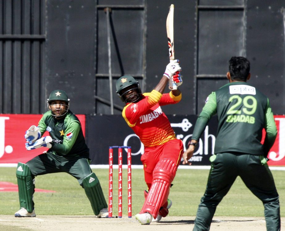 Zimbabwean batsman Solomon Mire, centre, plays a shot during the T20I cricket match against Pakistan at Harare Sports Club, in Harare, Zimbabwe on Wednesday. Zimbabwe is playing host to a tri-nation Twenty20 International series with Australia and Pakista