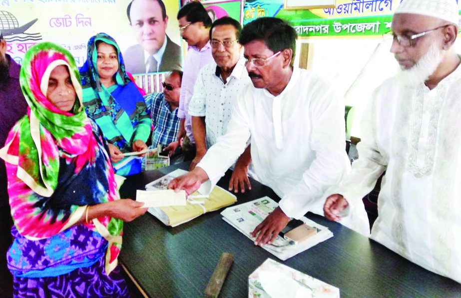 MURADNAGAR(Cumilla): Jahangir Alam Sarkar, General Secretary, Awami League, Cumilla North distributing cheque of loan among the poor people organised by Ministry of Women and Children Affairs as Chief Guest yesterday.
