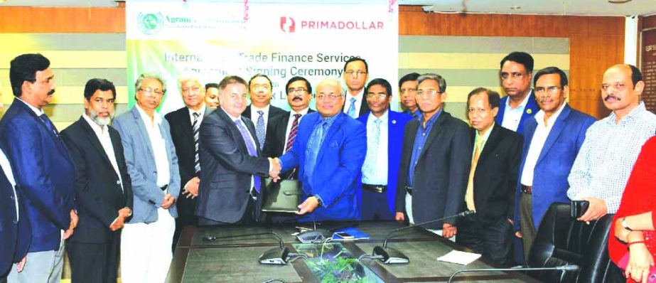 Mohammad Shams-Ul Islam, Managing Director of Agrani Bank Limited and Tim Nicolle, CEO of PrimaDollar Group, UK, exchanging an agreement signing document to cooperate in the provision of international trade finance services to exporters across Bangladesh
