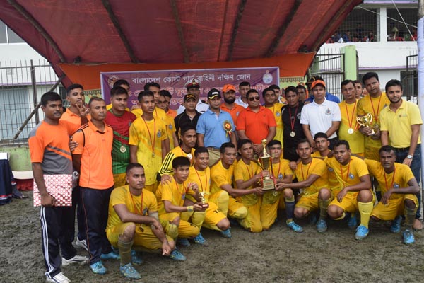 Members of East Zone Chattogram, The champions of the Inter-Zone Football Competition of Bangladesh Coast Guard with the chief guest Captain M Rakib Uddin Bhuiyan, the Commander of South Zone of Bangladesh Coast Guard with the other guests pose for a phot