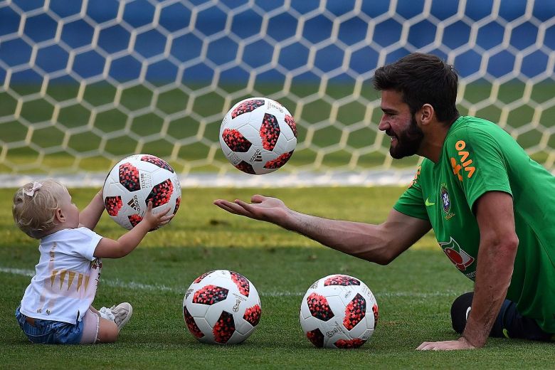 Brazil goalkeeper Alisson Becker, who has conceded only one goal in Russia, with his daughter Helena during a training session at the Yug Sport Stadium in Sochi, on Tuesday. His form will be vital for Tite's side.