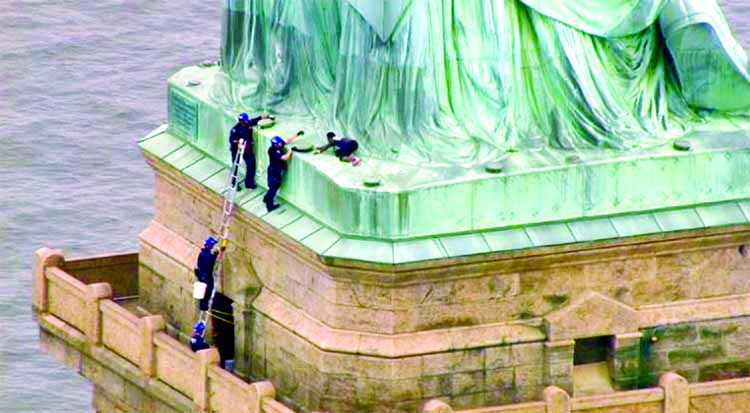 Police talking to a woman who climbed to the base of the Statue of Liberty in New York.