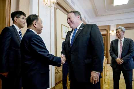 US Secretary of State Mike Pompeo, (second from right), greets Kim Yong Chol, a North Korean senior ruling party official and former intelligence chief, as they arrive for a meeting at the Park Hwa Guest House in Pyongyang on Friday