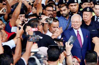 Malaysia's Najib sues three top officials involved in 1MDB corruption probe.