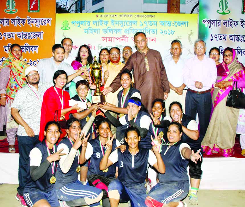 Rajshahi District team, the champions of the Popular Life Insurance 17th Inter-District Women's Volleyball Competition with the guests and officials of Bangladesh Volleyball Federation pose for a photo session at Nur Hossain National Volleyball Stadium o