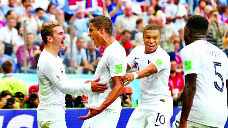 Raphael Varane (2nd from left) of France celebrates with team mates after scoring his team's first goal during the 2018 FIFA World Cup Russia Quarter Final match against Uruguay at Nizhny Novgorod Stadium, Russia on Friday.