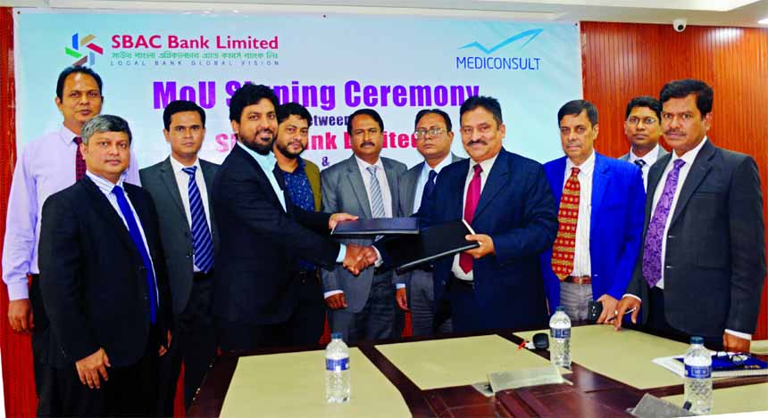 Mostafa Jalal Uddin Ahmed, Additional Managing Director of South Bangla Agriculture and Commerce (SBAC) Bank and Mostafizur Rahman, Managing Director of Mediconsult Limited, exchanging an MoU document at the bank's head office recently. The bank's DMD T