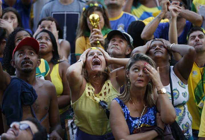 Brazil soccer fans cry out as they watch their team lose 2-1 to Belgium in a World Cup quarter final soccer match, on a live telecast.