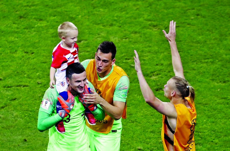 Croatia goalkeeper Danijel Subasic, goalkeeper Lovre Kalinic and Domagoj Vida, from left to right, celebrate after defeating Russia in a penalty shootout at the end of the quarterfinal match between Russia and Croatia at the 2018 soccer World Cup at the F