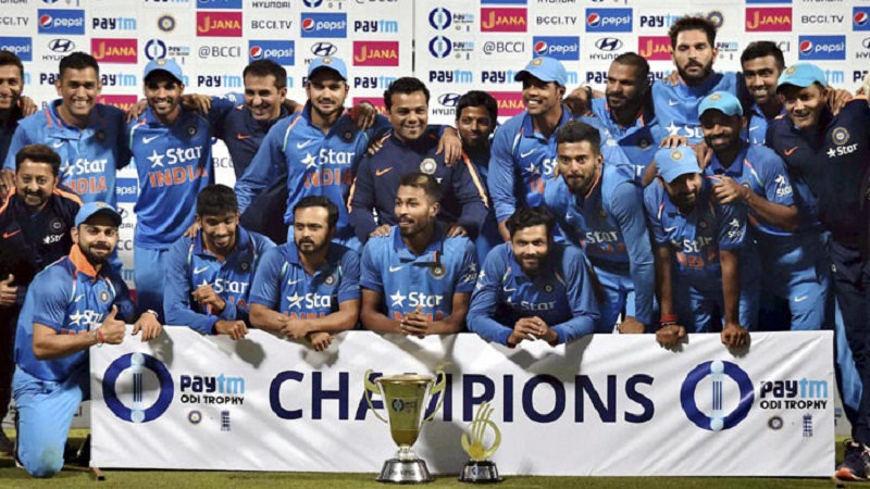 Indian cricketers pose for photo session with the series trophy on Sunday.