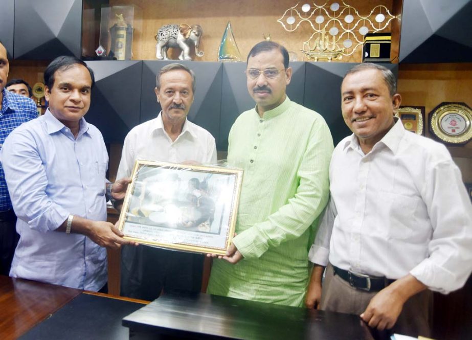 CCC Mayor A J M Nasir Uddin receiving a rare picture of Prime Minister Sheikh Hasina from photographer Shishir Barua at his office on Monday.