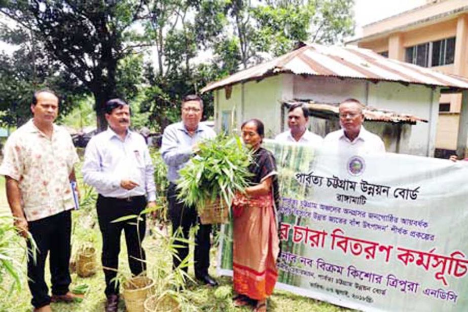 Chairman of Chattogram Hill Tracts Development Board Naba Bikram Kishore Tripura distributing bamboo saplings among marginal farmers in Rangamati town as Chief Guest recently.