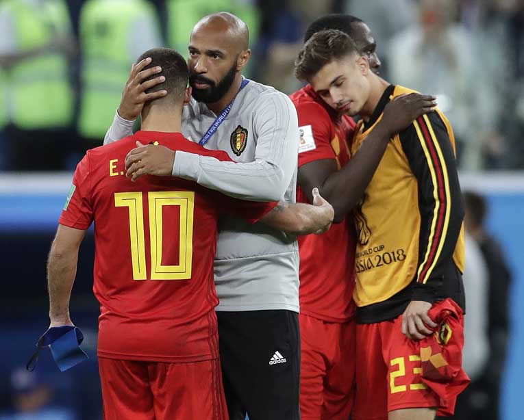 Belgium assistant coach Thierry Henry consoles Eden Hazard at the end of the semifinal match between France and Belgium at the 2018 soccer World Cup at the St. Petersburg Stadium in St. Petersburg, Russia on Tuesday.