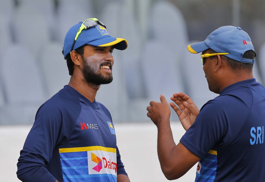 Sri Lanka's Dinesh Chandimal (left) speaks with spin bowling coach Piyal Wijetunge before a practice session ahead of the first test cricket match against South Africa in Galle, Sri Lanka on Wednesday. Sri Lanka will play a two- match Test series with to