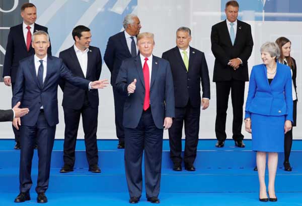 President Donald Trump and other leaders pose for a photo session at the start of the NATO summit in Brussels on Wednesday.