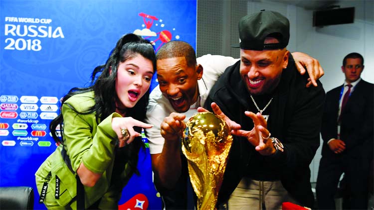Era Istrefi, Will Smith and Nicky Jam pose with the World Cup trophy at a press conference during the 2018 FIFA World Cup at Luzhniki Stadium in Moscow, Russia on Friday.