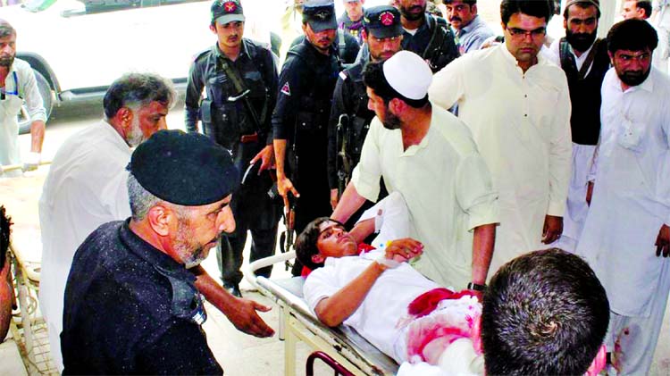 A Pakistani youth injured in a bomb blast is taken to a hospital in the country's northwest town of Bannu on Friday.