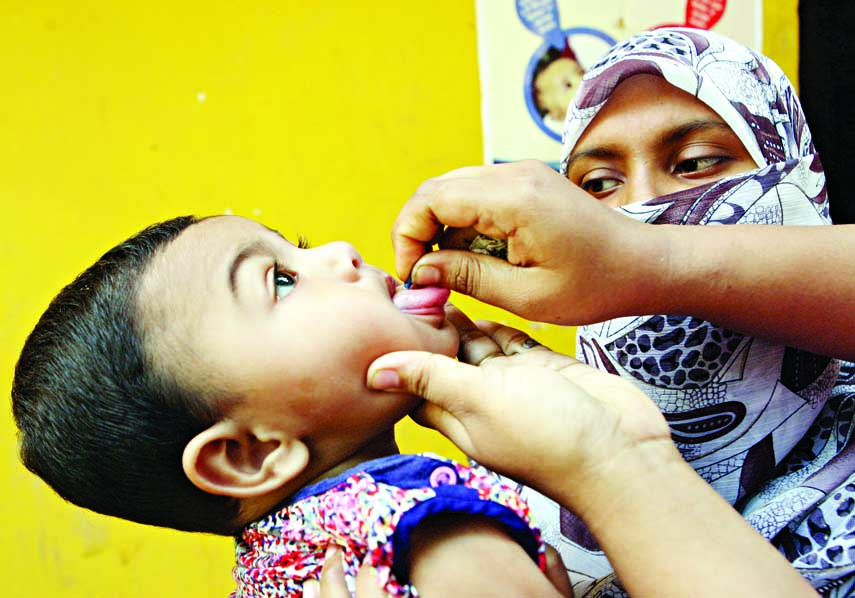 A child being administered Vitamin A capsule in the city's Shantibag High School on Saturday.