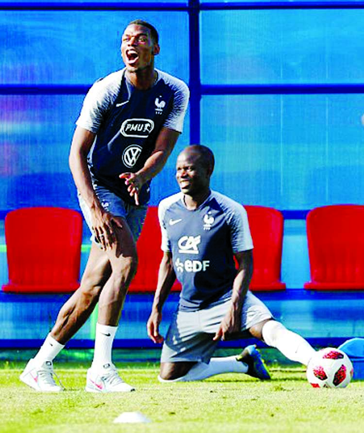 Paul Pogba enjoys a joke during a training session with his France team-mates on Thursday.