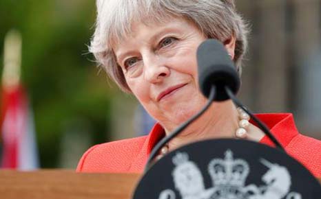 British Prime Minister Theresa May listens as she and U.S. President Donald Trump hold a press conference after their meeting at Chequers in Buckinghamshire.