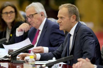 European Council President Donald Tusk, (right) speaks near European Commission President Jean-Claude Juncker during a meeting with Chinese Premier Li Keqiang, unseen at the Great Hall of the People in Beijing on Monday.