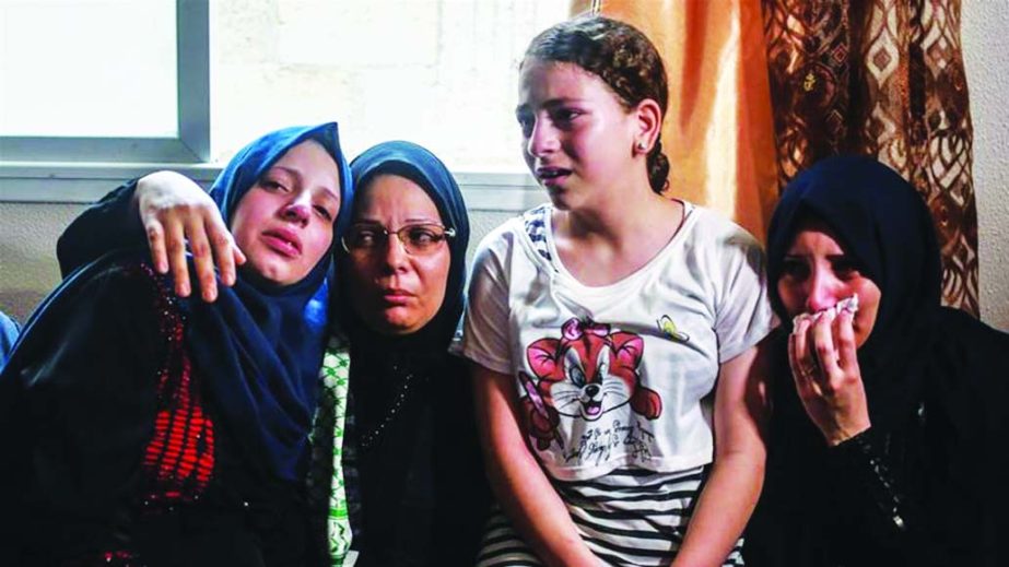 The mother of Amir al-Nimra, 15, second from left, and her three daughters at his funeral wake in Gaza.