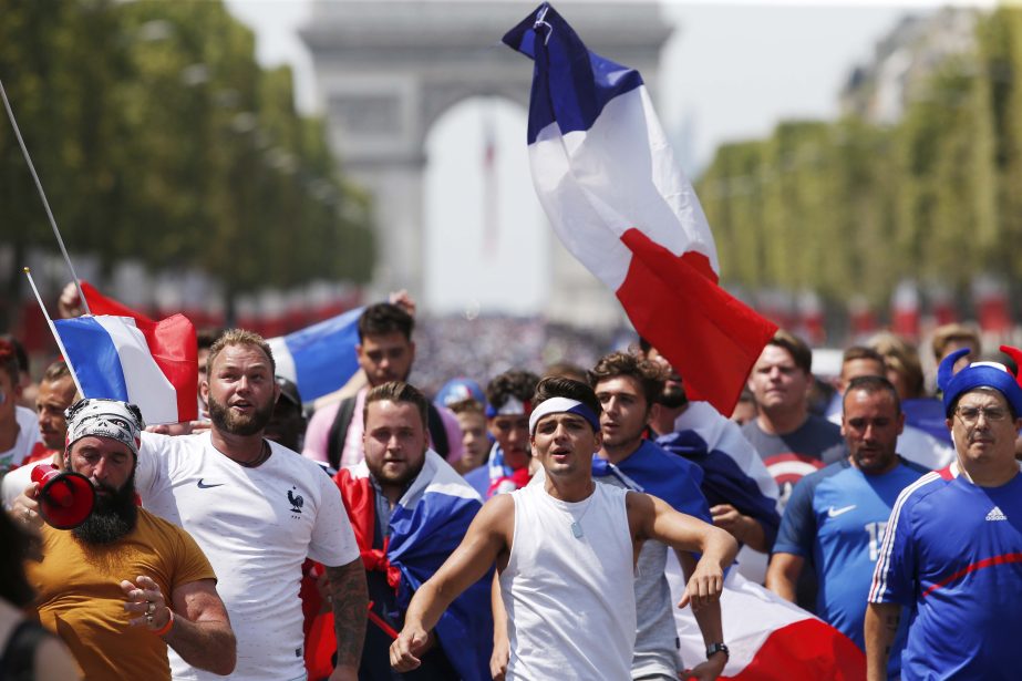 The crowd gathers to welcome the French soccer team for a parade a day after the French team victory in the soccer World Cup on Monday in Paris. France is ready to welcome home the national soccer team for a parade down the Champs-Elysees, where tens of t