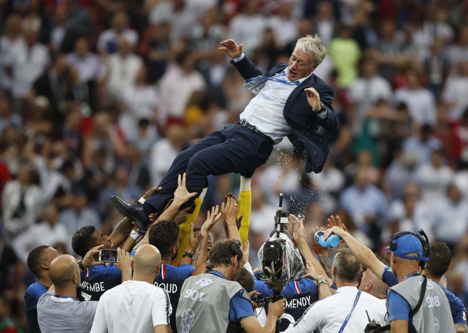 France head coach Didier Deschamps is thrown into the air by his players as they celibate after defeating Croatian in the match between France and Croatia at the 2018 soccer World Cup in the Luzhniki Stadium in Moscow, Russia, Sunday. France won the game