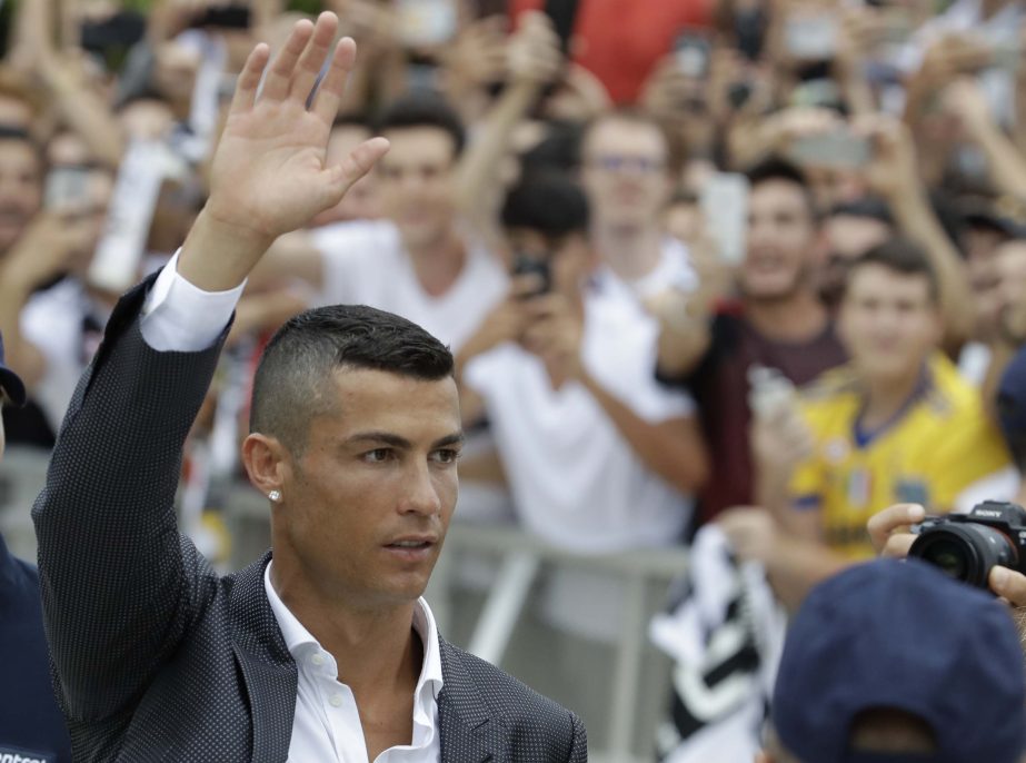 Portuguese ace Ronaldo salutes his fans as he arrives to undergo medical checks at the Juventus stadium in Turin, Italy on Monday.