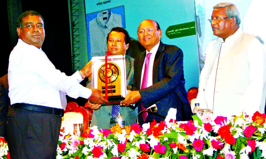 Sk. Momin Uddin, Managing Director of S.A.F Industries Limited, a sister concern of Akiz Group, is seen receiving the award (Gold) for outstanding contributions in export of leather sector for the year 2014-2015 from Commerce Minister Tofail Ahmed at Oman