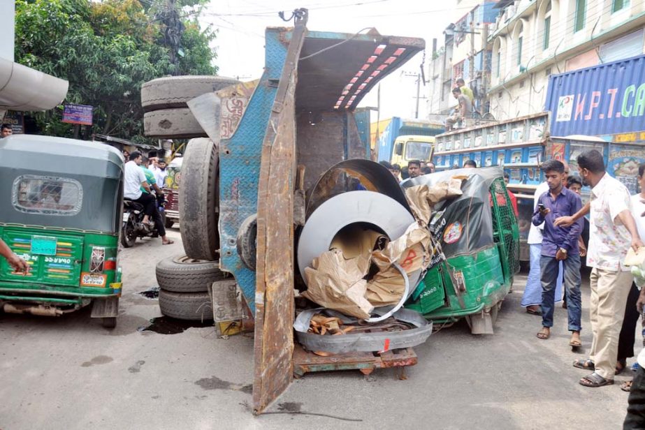 A goods laden truck turn off and hit a CNG running auto -rickshaw at Pahartoli in front of Abul Biri Factory at Pahartoli area yesterday.