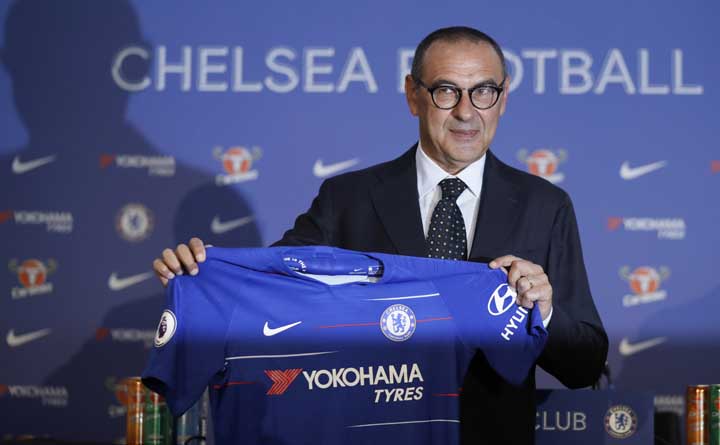 Maurizio Sarri, the new Chelsea soccer team manager, holds up a jersey during a press conference for his official presentation at Stamford Bridge stadium in London on Wednesday.