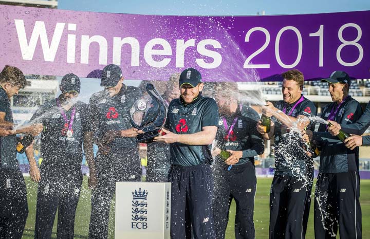 Eoin Morgan holds the trophy as he celebrates winning the series against India, with team mates, during the third One Day international between England and India, at Headingley in Leeds, England on Tuesday.