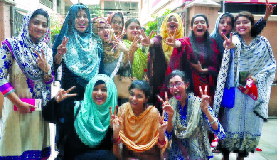 Teachers and students of the city's Motijheel Ideal School and College showing victory (V) sign for brilliant results of the institution in the HSC examination on its campus on Thursday.