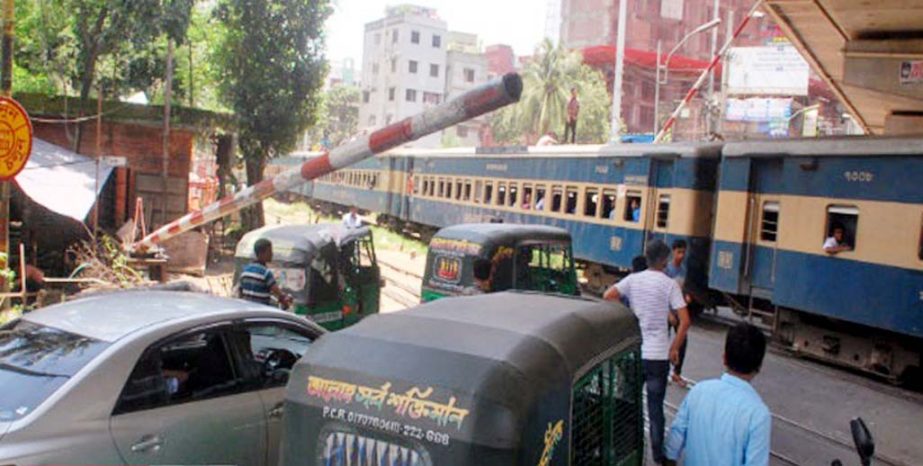 Different motorized vehicles trying to cross the rail line despite presence of rail crossing and gate bar risking accident anytime. The snap was taken from Maghbazar Rail Crossing in the city on Friday.