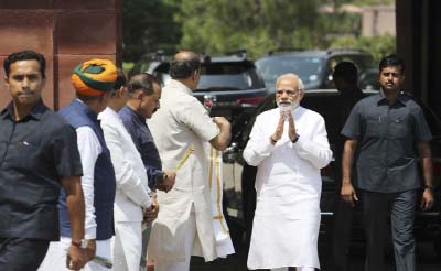 Indian Prime Minister Narendra Modi (second right) greets Cabinet colleagues as he arrives on the opening day of the monsoon session of the Indian Parliament in New Delhi, India.