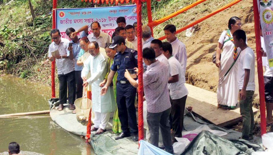 Kujendra Paul Tripura MP releasing fish fries in a pond of Khagrachhari Govt Girls' High School on the occasion of National Fisheries Week -2018 yesterday.