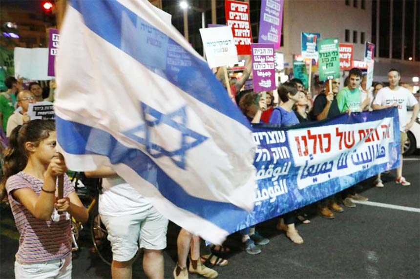 Protesters march against Israel's nation-state law in the city of Tel Aviv .