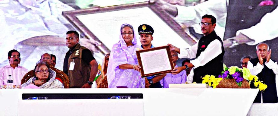 Prime Minister Sheikh Hasina receiving letter of honour from Awami League (AL) General Secretary and also Road, Transport and Bridges Minister Obaidul Quader at a reception accorded to her organised by AL at Suhrawardy Udyan in the city on Saturday. PID p