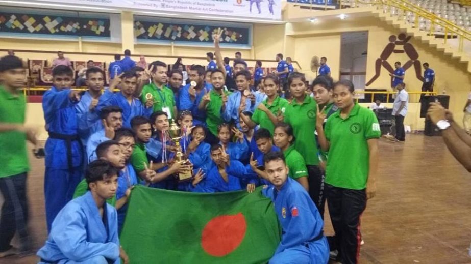 Members of Bangladesh Vovinam team, the champions of the 1st Sheikh Kamal South Asian Vovinam Championship pose for a photo session at the Shaheed Suhrawardy Indoor Stadium on Saturday.