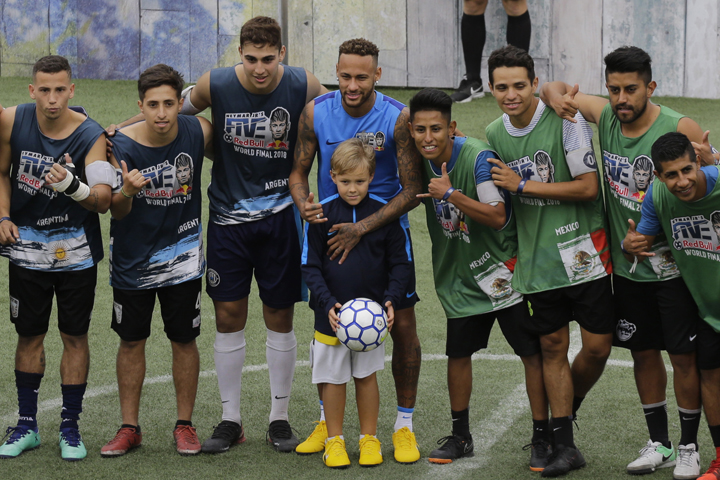 Brazilian soccer player Neymar and his son Davi Lucca pose for a group photo with players representing Argentina (left) and Mexico, at the Neymar Jr's Five youth soccer tournament in Praia Grande, Brazil on Saturday.
