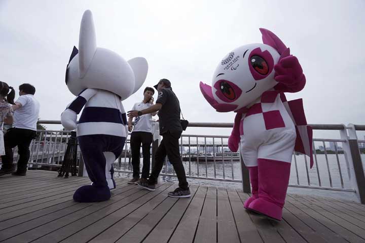 Tokyo 2020 Olympic mascot "Miraitowa"" (left) and Paralympic mascot ""Someity"" (right) walk on the pier after their water parade in Tokyo on Sunday. The official mascots for the Tokyo 2020 Olympics and Paralympics were unveiled at a ceremony on Sunday."