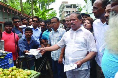 BARISHAL: BNP nominated mayor candidate Mojibor Rahman Sarwar distributing leaflets during a campaign in Barishal city on Sunday.